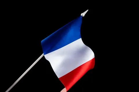 The flag of France on a black background developing flying in the wind Stock Photos