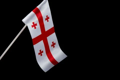 The flag of Georgia on a black background develops and flies waving in the wind Stockfoto's