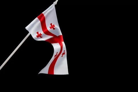 The flag of Georgia on a black background develops and flies waving in the wind Stock Photos
