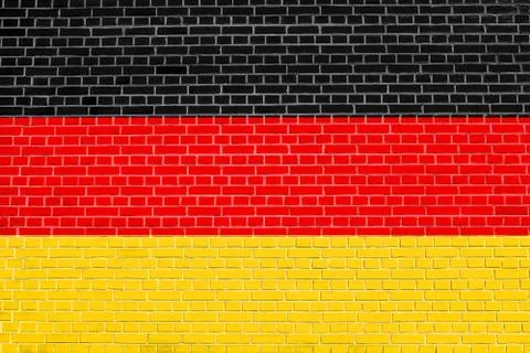 Flag of Germany on brick wall texture background. German national flag. Stock Photos