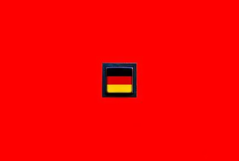 Flag of Germany on a simple square button on a solid red background. German.. Stock Photos