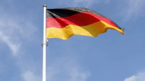 Flag of Germany waving in wind against blue sky Video stock 255144289