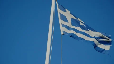 The flag of Greece develops against the sky - travel camera Video stock 174584953