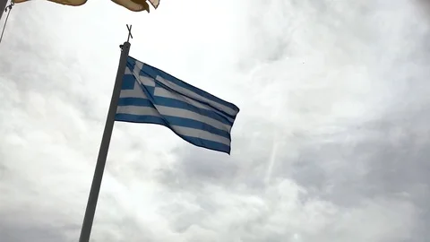 The flag of Greece flutters in the wind against the background of the sky Stock Footage 87589951