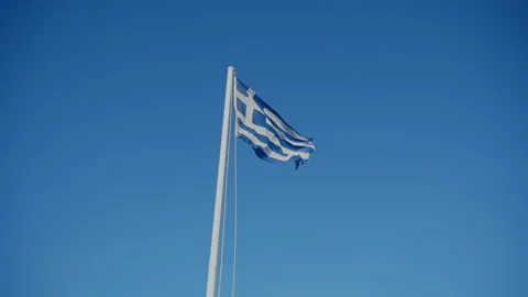 The flag of Greece is flying against the sky Stock Footage 174584284