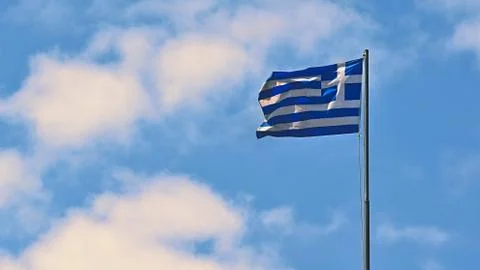 Flag of Greece Flying in Wind and Blue Sky. Summer background for travel and  스톡 사진