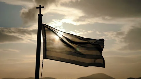 The flag of Greece flying in the wind on a ship sailing on the sea at dusk. 4K 動画素材 116401271