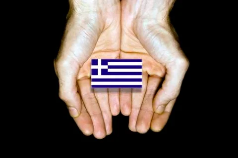 Flag of Greece in hands on black background Stock Photos