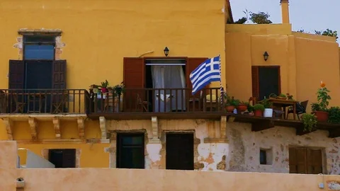 Flag of Greece waving on wind hanging on local`s balcony of house Video stock 106775055