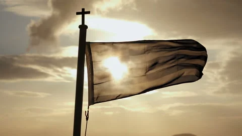The flag of Greece waving in the wind on a ship sailing on sea at sunset. 4K Video stock 116306375