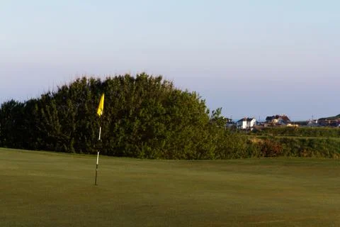 Flag on the green at golf course Photos