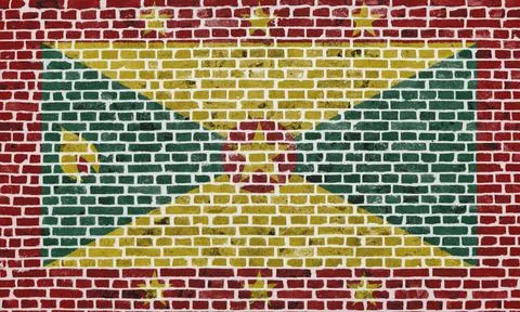 Flag of Grenada painted on a brick wall Stock Illustration