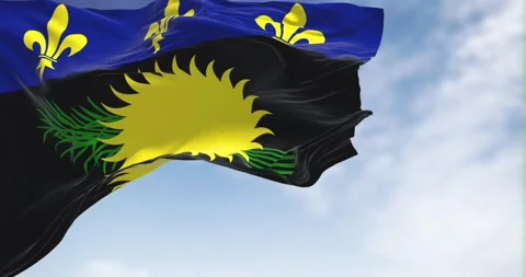 Flag of Guadeloupe waving in the wind on a clear day Stock Footage 202037700
