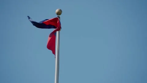 Flag of Haiti waving with clear blue sky in background. Close-up Stock Footage 318965229