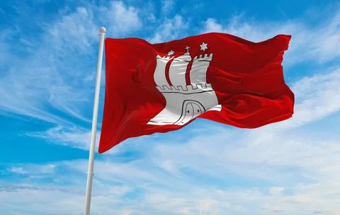 Flag of Hamburg at cloudy sky background on sunset, panoramic view. Federal R Illustrazione stock