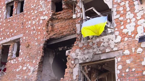 Flag hangs from brick buildings side, adding color to the facade Stock Footage 274572394