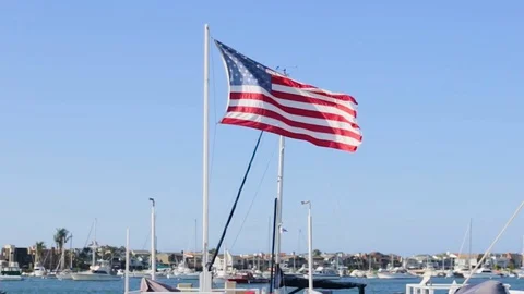 Flag At a Harbor Full of Boats Stock Footage 91738822
