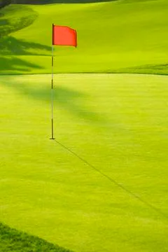 Flag in hole on golf course Photos