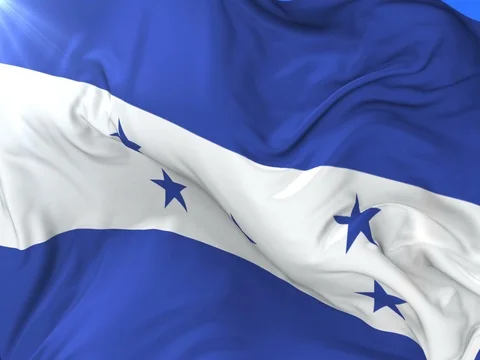 Flag of Honduras waving at wind with blue sky in slow, loop Vídeos de archivo 81779220