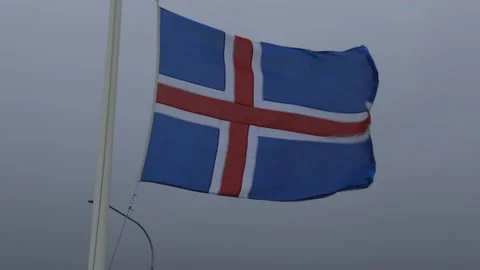 Flag of Iceland waving on pole in wind and cloudy weather Видео 227904474