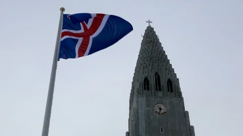 Flag of Iceland waving in wind in front of Hallgrimskirkja the symbol of Iceland Stock Footage 93219152
