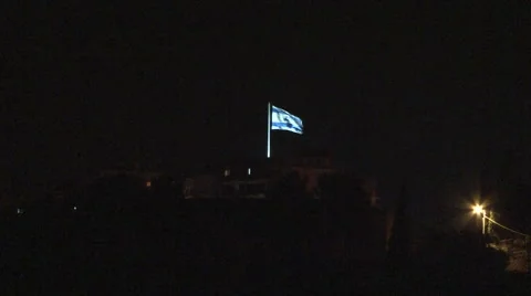 Flag of Israel flying on top of Mount of Olives - night 스톡 동영상 49761802