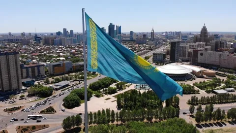 The flag of Kazakhstan is developing in the wind.Astana - Nur Sultan.Drone Stock Footage 131232143