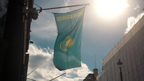 Flag of Kazakhstan flies flutter on a building with the sun shining back into Stock Footage 281082005