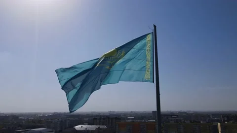 The flag of Kazakhstan Republic is flying in the wind against the blue sky. High Stock Footage 237161546