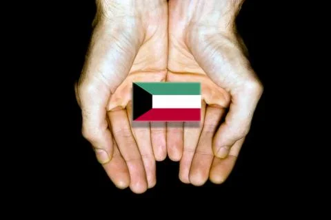 Flag of Kuwait in hands on black background Stock Photos