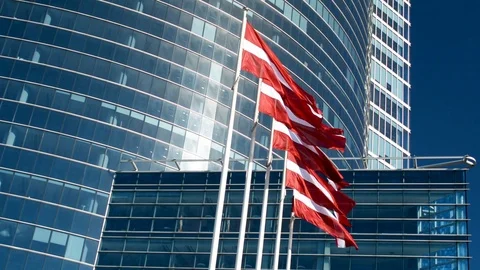 Flag of Latvia in front of an office skyscraper building on a sunny summer day 動画素材 89542163