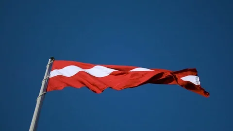 Flag of Latvia on huge high flagpole blowing in the wind 库存影片 91574482