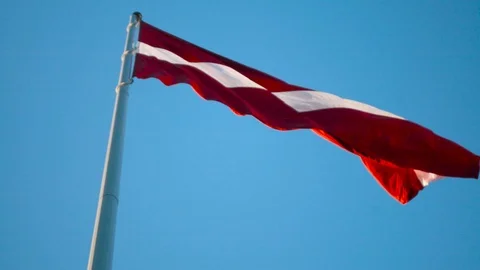 Flag of Latvia on huge high flagpole blowing in the wind Stockbeeldmateriaal 91575587
