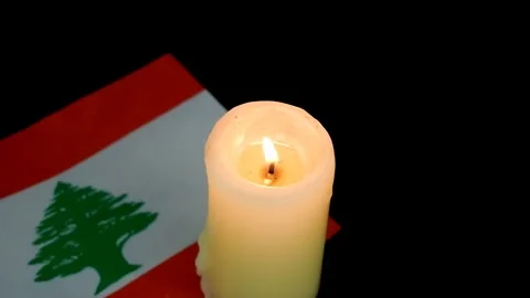 Flag of Lebanon and single burning candle on black Stock Footage 288862512