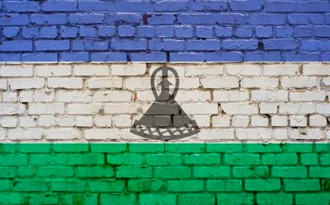 Flag of Lesotho painted on brick wall, background texture Stock Photos