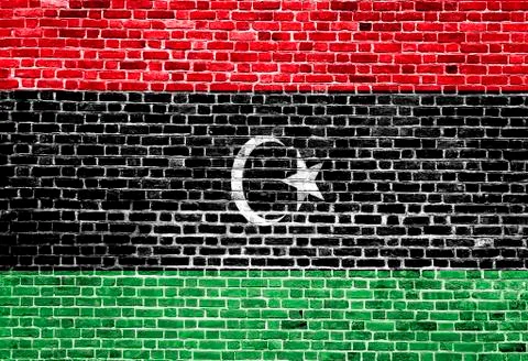 Flag of Libya painted on brick wall, background texture Stock Photos