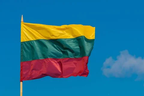 The flag of Lithuania flying in breeze wind on sky background Stock Photos