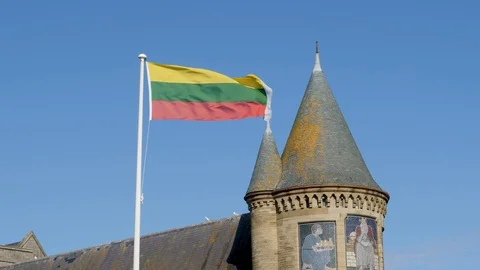 Flag of Lithuania waves over University Aberystwyth Wales Stock Footage 96048384