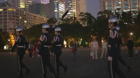 Flag lowering ceremony - soliders march towards memorial hall Stock Footage 43741187