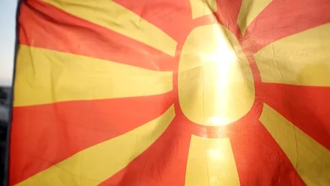  Flag of Macedonia flapping in the wind against clean blue sky Stock Footage 93578776