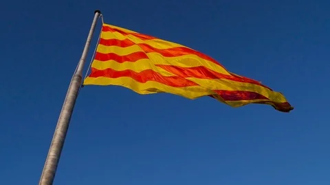 The flag of Malta flies against the background of a bright blue sky. Island Stock Footage 101199344