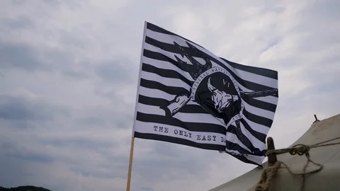The flag of the military unit is flying over the tent. In the military camp Stock Footage 130114965