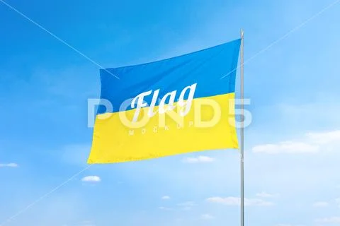 Flag  mockup with clean texture against a vibrant blue sky PSD Template