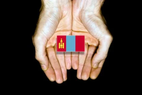 Flag of Mongolia in hands on black background Stock Photos
