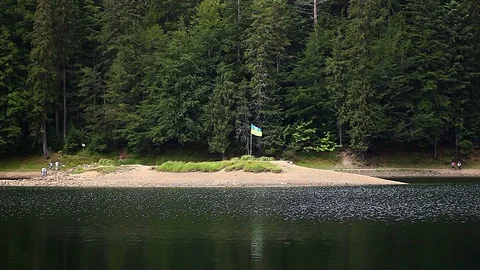 Flag on the mountain lake Stock Footage 97292528
