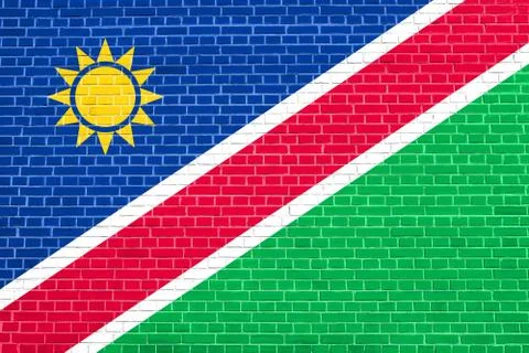 Flag of Namibia on brick wall texture background Stock Photos