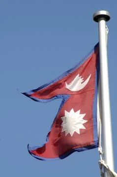 The flag of Nepal against blue sky Stock Photos