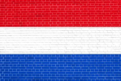 Flag of Netherlands on brick wall texture background Stock Photos