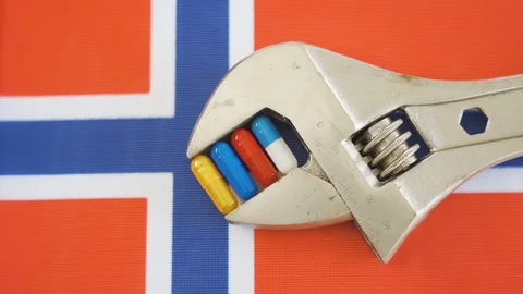 The flag of Norway with the silver wrench on the table Stock Footage 129339875