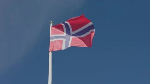 Flag of Norway waving in the wind against blue sky Stock Footage 158884005